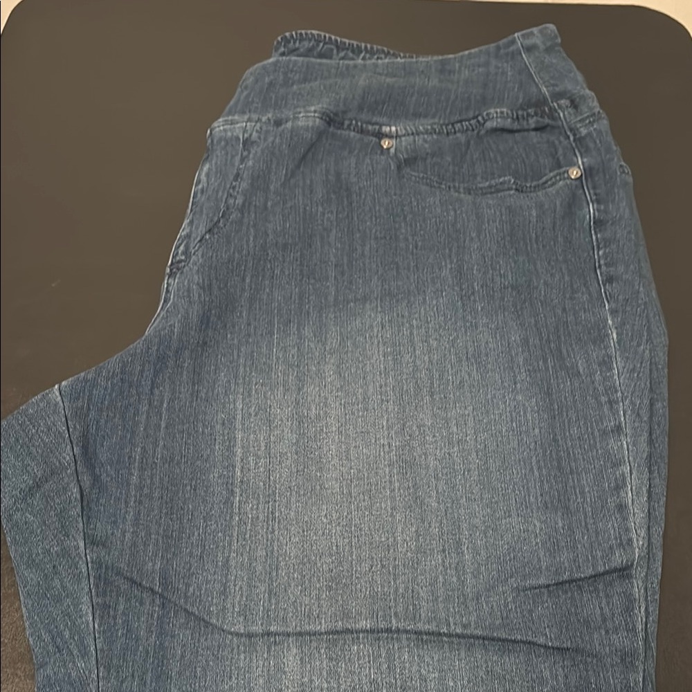 Belle by Kim Gravel jeans with cut out diagonal hem seam. 
Women's Blue Jeans